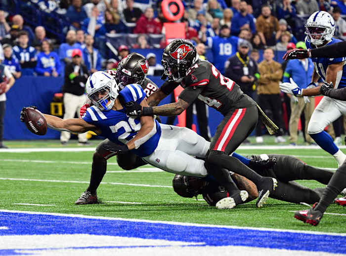 Nov 26, 2023; Indianapolis, Indiana, USA; Indianapolis Colts running back Jonathan Taylor (28) drives for a touchdown but falls short for a first down against Tampa Bay Buccaneers cornerback Carlton Davis III (24) and safety Christian Izien (29) at Lucas Oil Stadium.